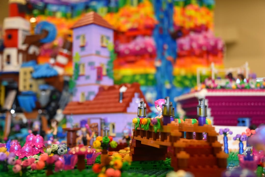 Fantasy LEGO build – vibrant display with flora, bridge, and castle